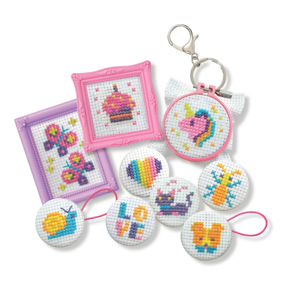 Kit contents laid out: coloured threads, button hoops, patterns and the instruction sheet
