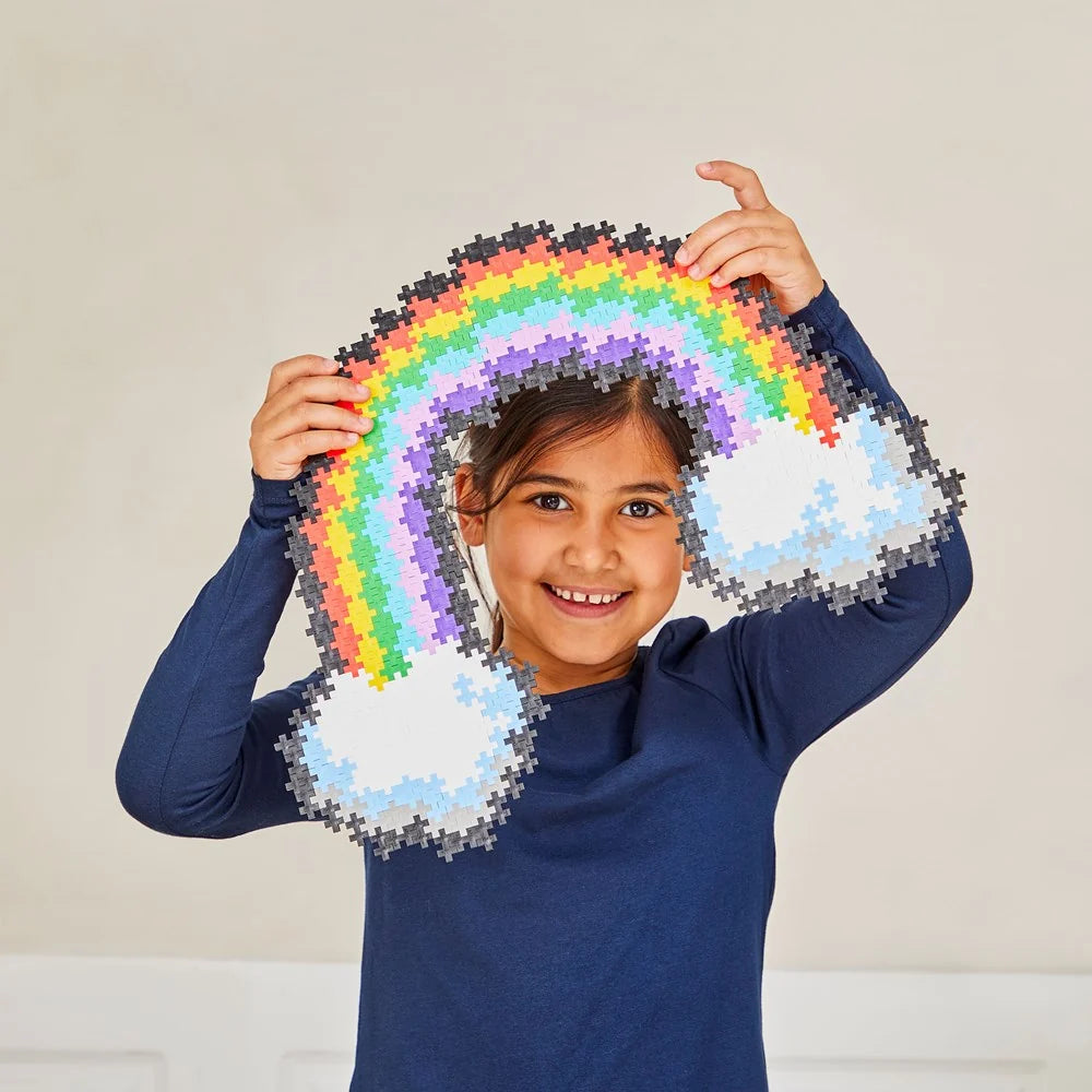 The ten Plus-Plus colours in the rainbow set, sorted into separate piles on a white surface