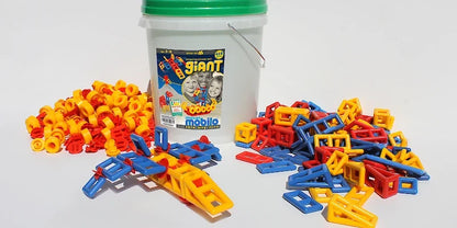 Mobilo Giant Bucket construction set with 416 pieces, shown with red, yellow and blue connectors and geometric shapes beside a small aeroplane model