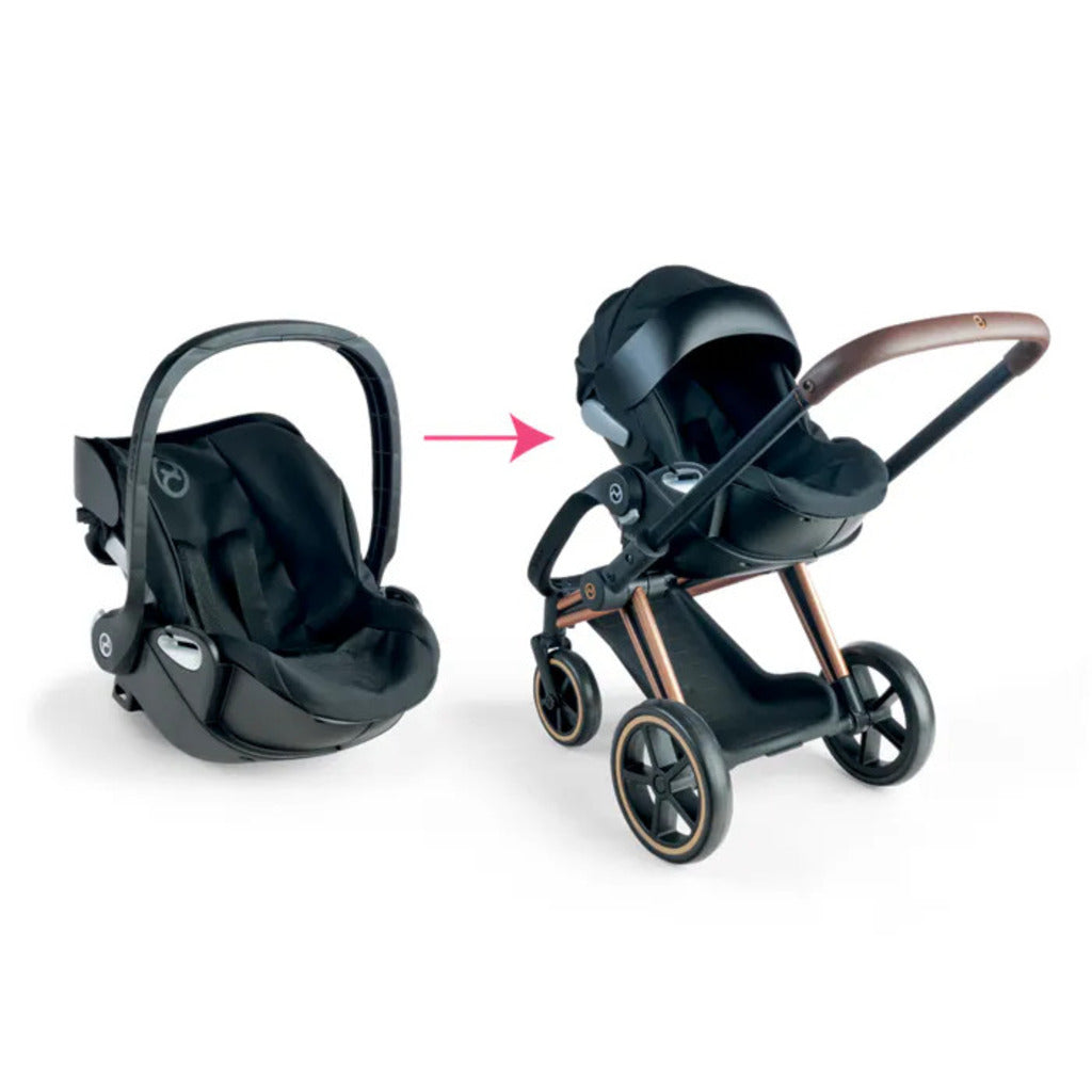 Close-up of the doll pram wheels and black frame, modelled on the real Cybex Priam pram