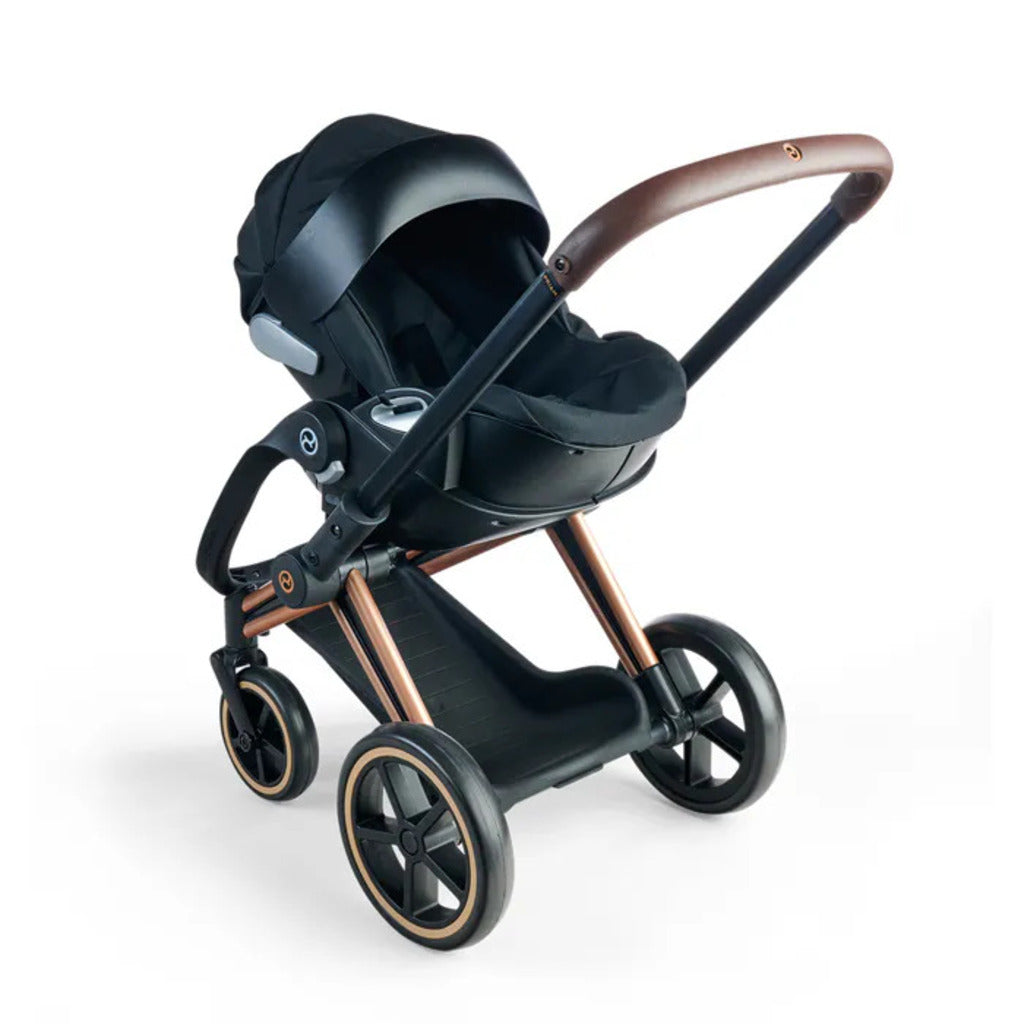 The protective cover fitted over the black Corolle x Cybex 3-in-1 doll pram to shelter the doll inside