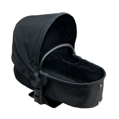 Carrycot mode on the Corolle x Cybex 3-in-1 doll pram, with a newborn doll lying flat inside