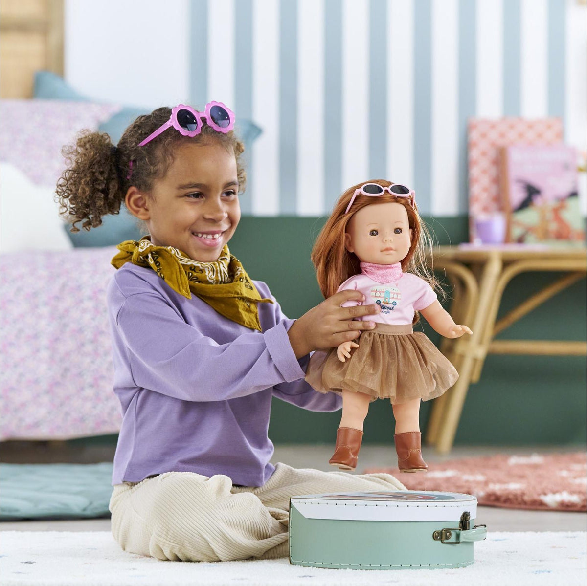 Child dressing a 36cm Ma Corolle doll in the Corolle Festival Outfit