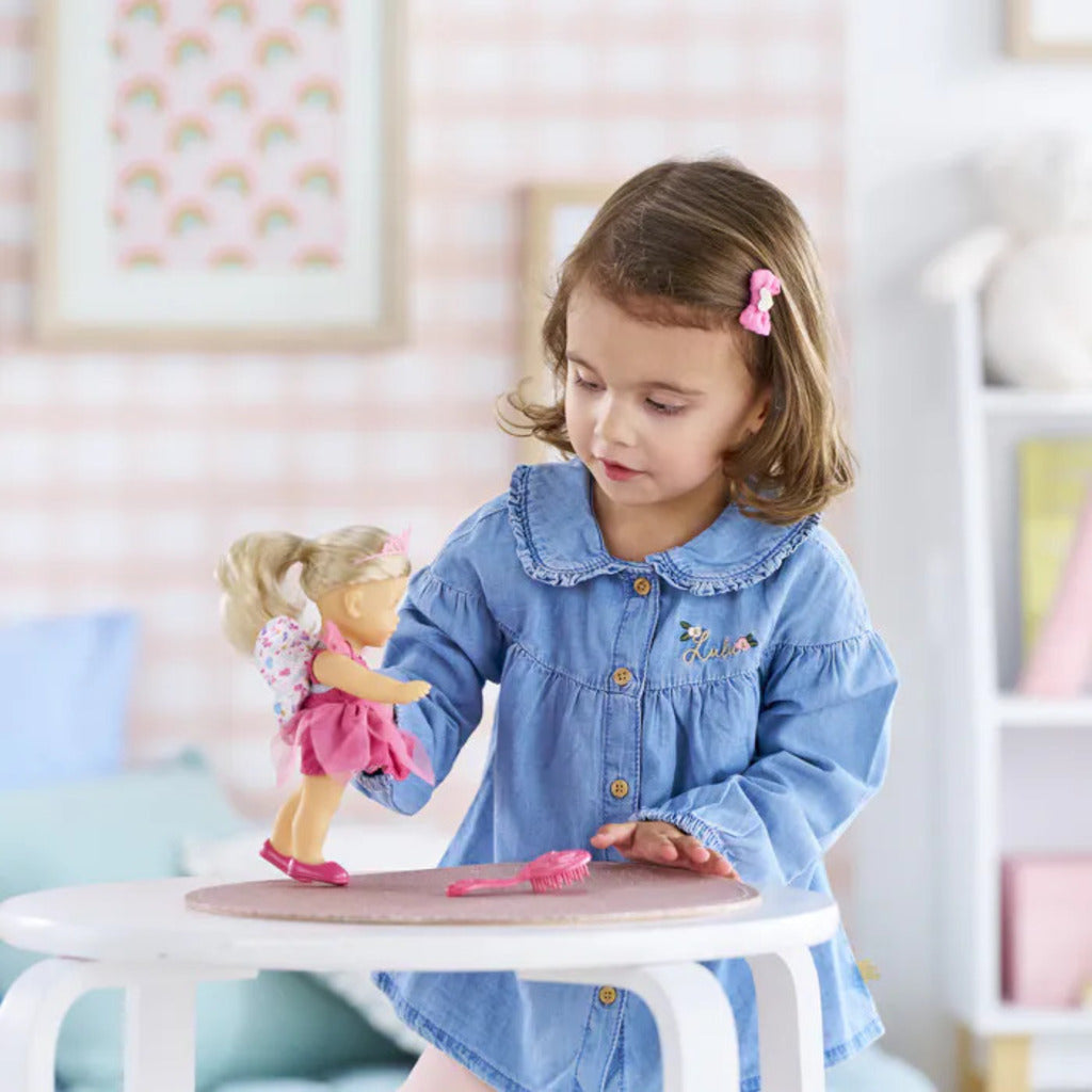 Side view of the 20cm Rosy fairy doll showing her soft all-vinyl body and fairy outfit