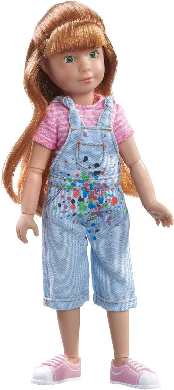 Kruselings Chloe doll wearing paint-splatter overalls and pink shoes with poseable joints