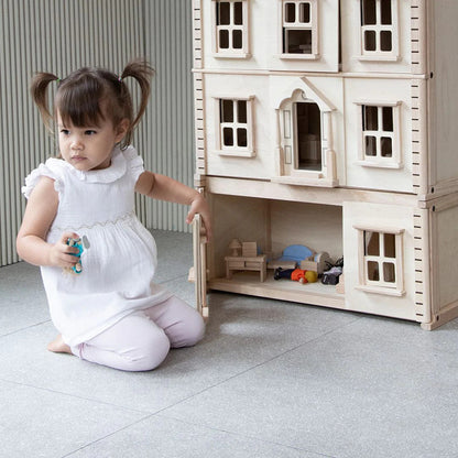 PlanToys wooden dollhouse basement extension with staircase, windows and natural wood finish for imaginative pretend play.