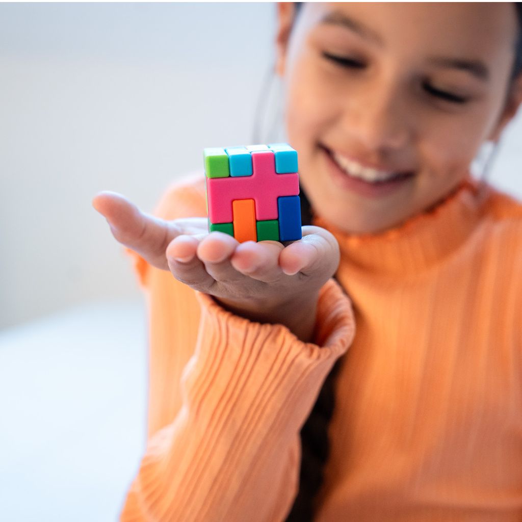IQ Quub puzzle pieces stacked into a complete 3D cube, showing the second way to play the challenges