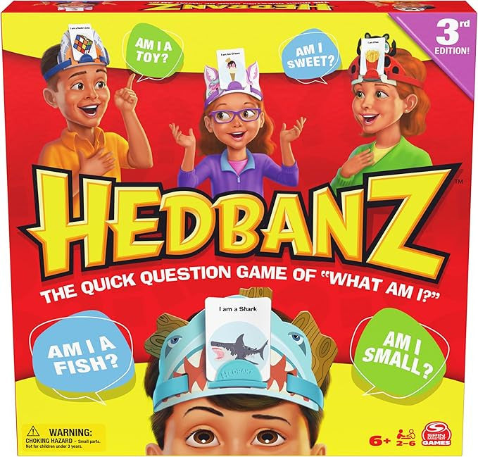 Spin Master Hedbanz 3rd Edition guessing game box featuring children wearing headbands and asking what am I questions